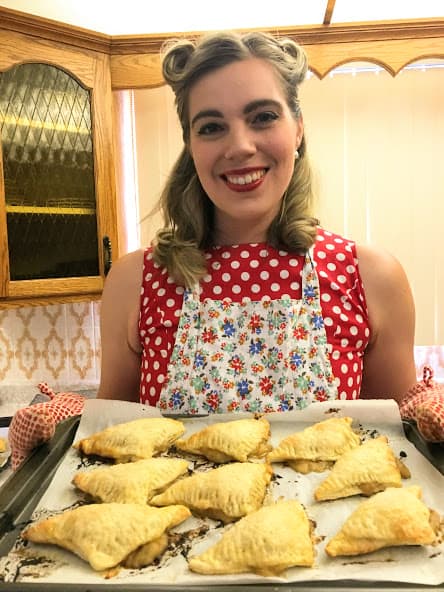 holding a tray of early fall apple turnovers
