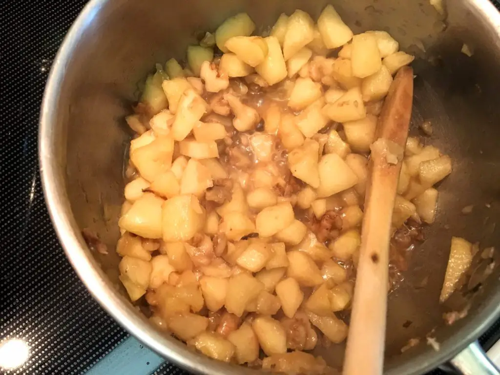 Apples, walnuts and maple syrup on the stove