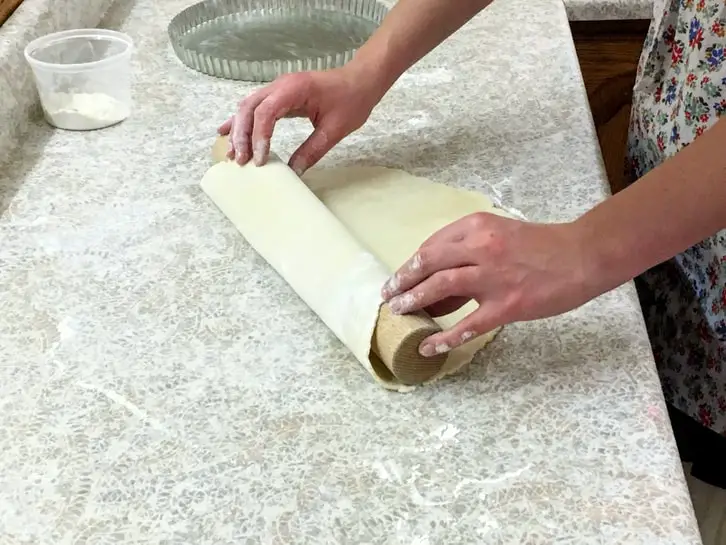 transferring rolled out dough to a pie plate