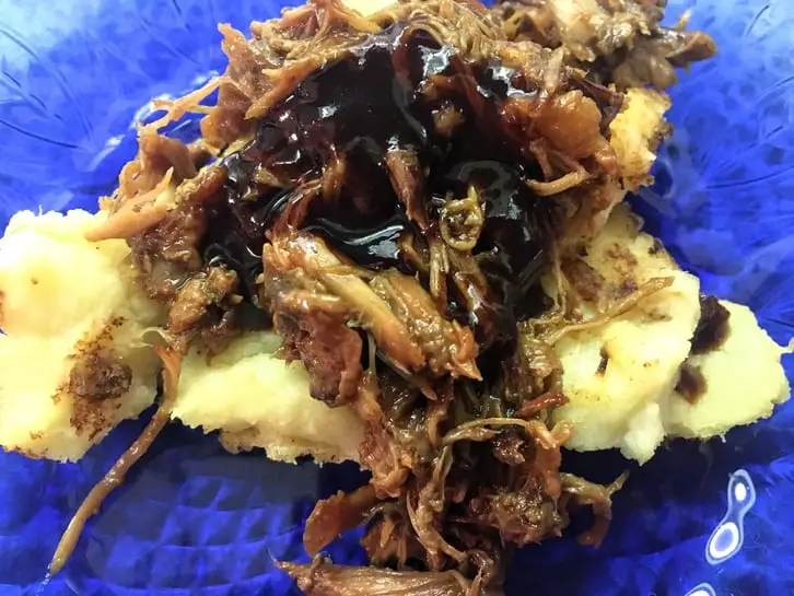 barbecue pulled duck on mashed potatoes