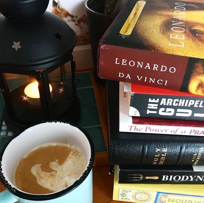 stack of books, coffee and candle