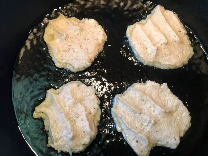 frying German Potato Pancakes in a cast-iron skillet