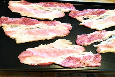bacon cooking on a raclette grill