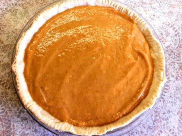 raw maple bourbon pumpkin pie filling in shell