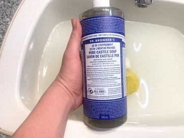 Dr. Bronners Peppermint Castile Soap over a sink of water